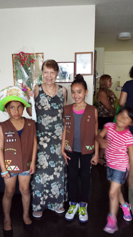 Volunteers from Roosevelt Island Girl Scouts Troop 3001 and a Senior at an Art Gallery
